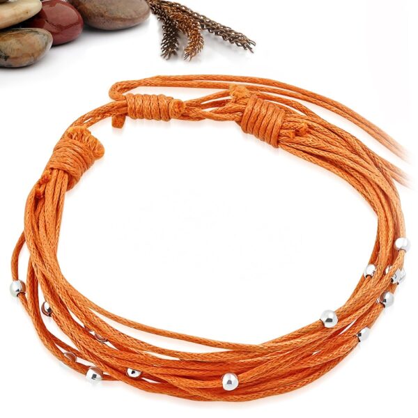 Narancs sárga színű szövet karkötő, fém dísszel