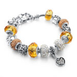 Szives Pandora stílusú kristályos karkötő - Borostyán