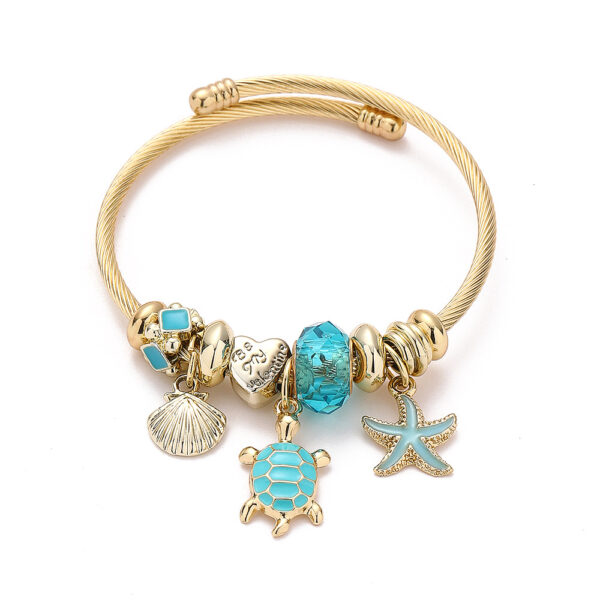 Arany színű teknősös pandora stílusú charm kristályos karkötő - Kék
