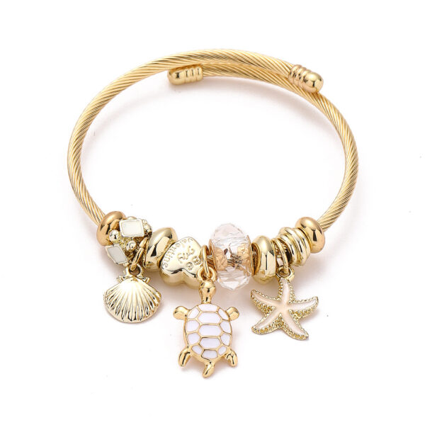 Arany színű teknősös pandora stílusú charm kristályos karkötő - Kristály